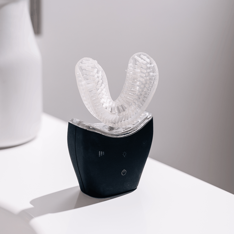 Autobrush Sonic Pro U-shaped electric toothbrush with silicone bristles and sonic vibration technology in black and clear design