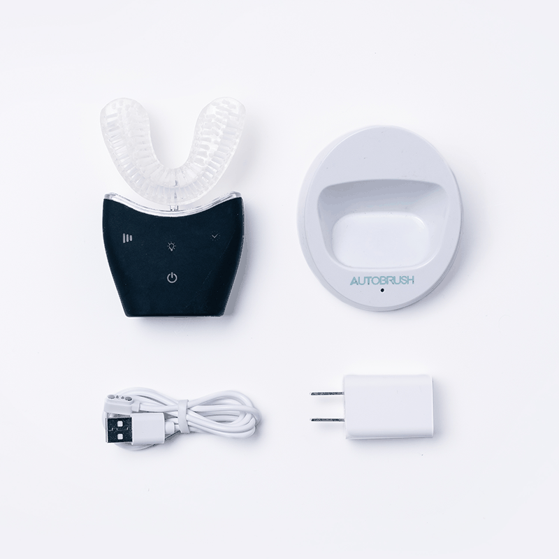 Autobrush Sonic Pro electric toothbrush with U-shaped silicone bristles, charging base, USB cable, and power adapter.
